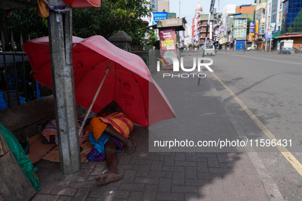 A man sleeps on the street in Colombo, Sri Lanka, on September 22, 2024. A curfew is imposed in Sri Lanka amid the counting of votes in the...