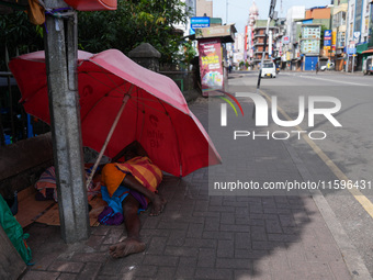 A man sleeps on the street in Colombo, Sri Lanka, on September 22, 2024. A curfew is imposed in Sri Lanka amid the counting of votes in the...