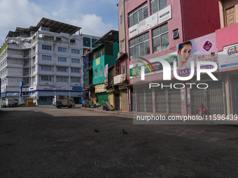 A man sits on the empty street in Colombo, Sri Lanka, on September 22, 2024. A curfew is imposed in Sri Lanka amid the counting of votes in...