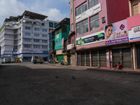 A man sits on the empty street in Colombo, Sri Lanka, on September 22, 2024. A curfew is imposed in Sri Lanka amid the counting of votes in...