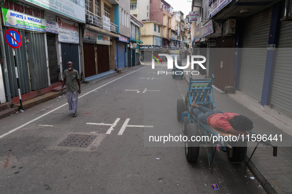 A man sleeps on the cart in Colombo, Sri Lanka, on September 22, 2024. A curfew is imposed in Sri Lanka amid the counting of votes in the pr...