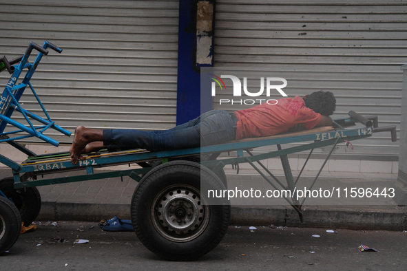 A man sleeps on the cart in Colombo, Sri Lanka, on September 22, 2024. A curfew is imposed in Sri Lanka amid the counting of votes in the pr...