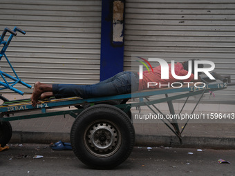 A man sleeps on the cart in Colombo, Sri Lanka, on September 22, 2024. A curfew is imposed in Sri Lanka amid the counting of votes in the pr...