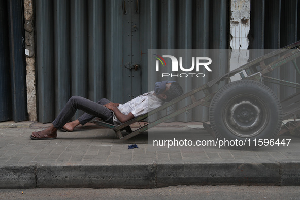 A man sleeps on the cart in Colombo, Sri Lanka, on September 22, 2024. A curfew is imposed in Sri Lanka amid the counting of votes in the pr...