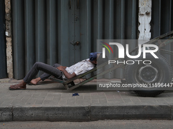 A man sleeps on the cart in Colombo, Sri Lanka, on September 22, 2024. A curfew is imposed in Sri Lanka amid the counting of votes in the pr...