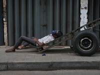 A man sleeps on the cart in Colombo, Sri Lanka, on September 22, 2024. A curfew is imposed in Sri Lanka amid the counting of votes in the pr...