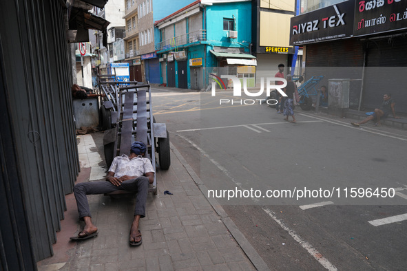 A man sleeps on the cart in Colombo, Sri Lanka, on September 22, 2024. A curfew is imposed in Sri Lanka amid the counting of votes in the pr...