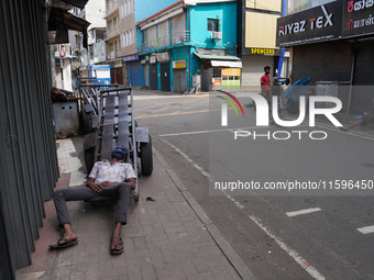 A man sleeps on the cart in Colombo, Sri Lanka, on September 22, 2024. A curfew is imposed in Sri Lanka amid the counting of votes in the pr...