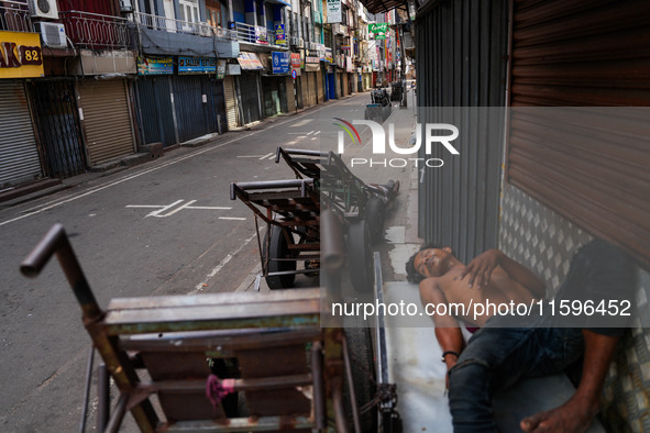 A man sleeps on the cart in Colombo, Sri Lanka, on September 22, 2024. A curfew is imposed in Sri Lanka amid the counting of votes in the pr...