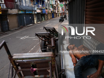 A man sleeps on the cart in Colombo, Sri Lanka, on September 22, 2024. A curfew is imposed in Sri Lanka amid the counting of votes in the pr...