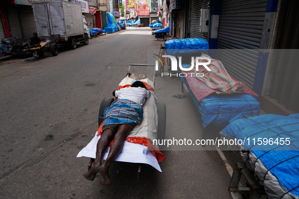 A man sleeps on the cart in Colombo, Sri Lanka, on September 22, 2024. A curfew is imposed in Sri Lanka amid the counting of votes in the pr...