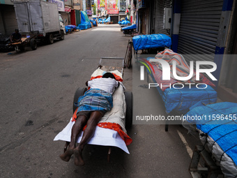 A man sleeps on the cart in Colombo, Sri Lanka, on September 22, 2024. A curfew is imposed in Sri Lanka amid the counting of votes in the pr...