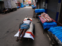 A man sleeps on the cart in Colombo, Sri Lanka, on September 22, 2024. A curfew is imposed in Sri Lanka amid the counting of votes in the pr...