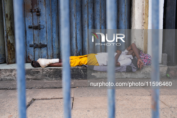 Vendors sleep during the curfew in Colombo, Sri Lanka, on September 22, 2024. Curfew is imposed in Sri Lanka amid the counting of votes in t...