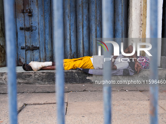 Vendors sleep during the curfew in Colombo, Sri Lanka, on September 22, 2024. Curfew is imposed in Sri Lanka amid the counting of votes in t...