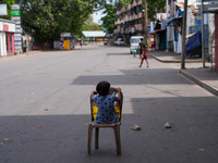 A kid sits on a chair on an empty street in Colombo, Sri Lanka, on September 22, 2024. A curfew is imposed in Sri Lanka amid the counting of...