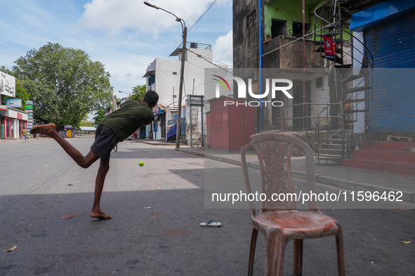 Kids play cricket during the curfew in Colombo, Sri Lanka, on September 22, 2024. The curfew is imposed in Sri Lanka amid the counting of vo...