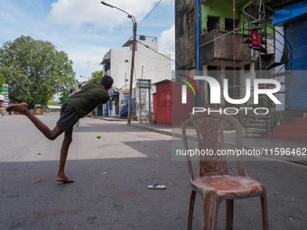 Kids play cricket during the curfew in Colombo, Sri Lanka, on September 22, 2024. The curfew is imposed in Sri Lanka amid the counting of vo...