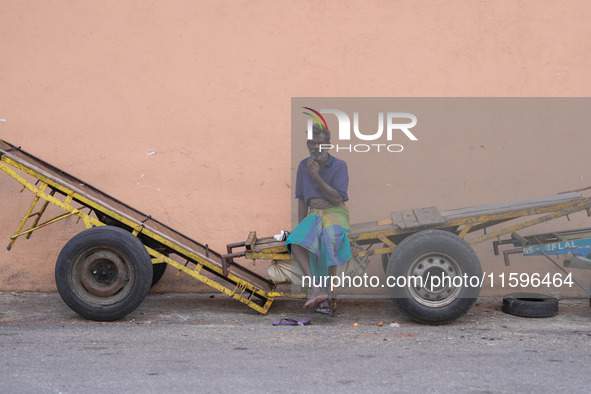 A laborer sits at the cart in Colombo, Sri Lanka, on September 22, 2024. A curfew is imposed in Sri Lanka amid the counting of votes in the...