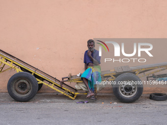 A laborer sits at the cart in Colombo, Sri Lanka, on September 22, 2024. A curfew is imposed in Sri Lanka amid the counting of votes in the...