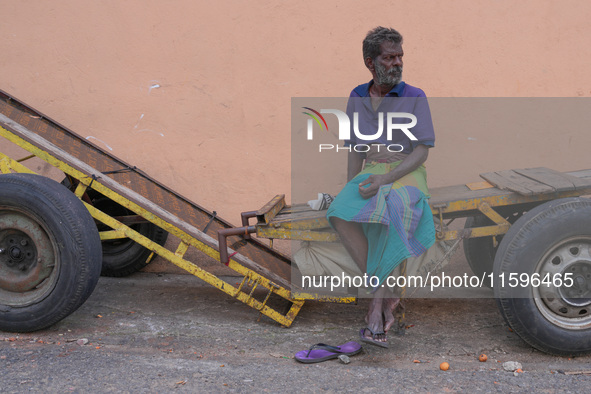 A laborer sits at the cart in Colombo, Sri Lanka, on September 22, 2024. A curfew is imposed in Sri Lanka amid the counting of votes in the...