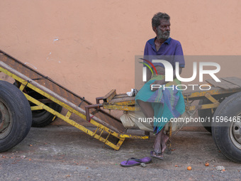 A laborer sits at the cart in Colombo, Sri Lanka, on September 22, 2024. A curfew is imposed in Sri Lanka amid the counting of votes in the...