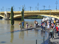 People take photos on the bank of the Danube in Budapest, Hungary, as the peak water levels of the Danube are expected to hit today. (