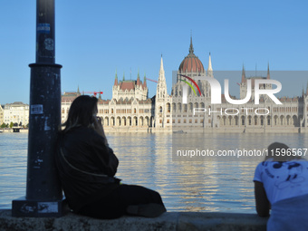 People look at the parliament on the bank of the Danube in Budapest, Hungary, as the peak water levels of the Danube are expected to hit. (