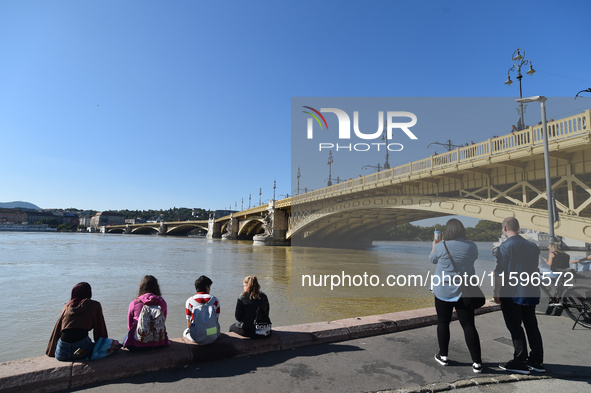 People look at the Danube in Budapest, Hungary, on Month Day, Year, as the peak water levels of the Danube are expected to hit. 