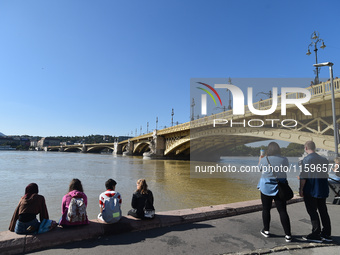 People look at the Danube in Budapest, Hungary, on Month Day, Year, as the peak water levels of the Danube are expected to hit. (