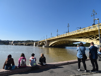 People look at the Danube in Budapest, Hungary, on Month Day, Year, as the peak water levels of the Danube are expected to hit. (