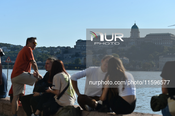 People stand on the bank of the Danube in Budapest, Hungary, as the peak water levels of the Danube are expected to hit today. 