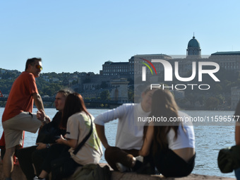 People stand on the bank of the Danube in Budapest, Hungary, as the peak water levels of the Danube are expected to hit today. (