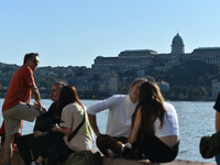 People stand on the bank of the Danube in Budapest, Hungary, as the peak water levels of the Danube are expected to hit today. (