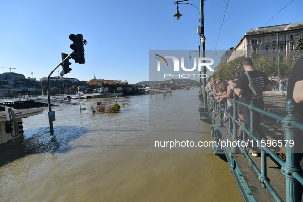 People look at the Danube in Budapest, Hungary, on Month Day, Year, as the peak water levels of the Danube are expected to hit. 