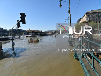 People look at the Danube in Budapest, Hungary, on Month Day, Year, as the peak water levels of the Danube are expected to hit. (