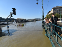 People look at the Danube in Budapest, Hungary, on Month Day, Year, as the peak water levels of the Danube are expected to hit. (