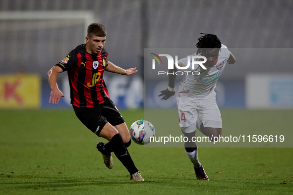 Oluwatobiloba Dimeji Awosanya (R) of Balzan competes for the ball with Sven Xerri (L) of Hamrun Spartans during the Malta 360 Sports Premier...