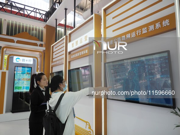 Visitors visit the ''Highway Network Operation Monitoring System'' at the 16th International Transportation Technology and Equipment Exhibit...