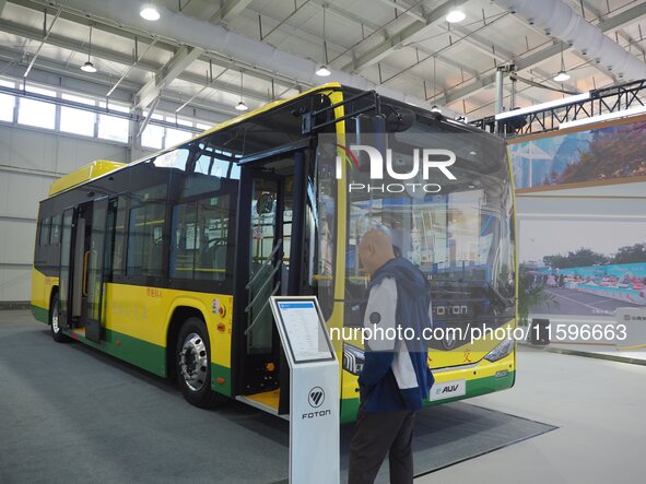 Visitors view a ''pure electric bus'' at the 16th International Transportation Technology and Equipment Exhibition in Beijing, China, on Sep...