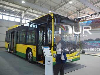 Visitors view a ''pure electric bus'' at the 16th International Transportation Technology and Equipment Exhibition in Beijing, China, on Sep...