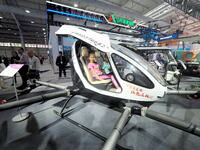 A child experiences an electric unmanned aircraft at the 16th International Transportation Technology and Equipment Exhibition in Beijing, C...