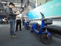 Visitors look at a ''hydrogen two-wheeled vehicle'' at the 16th International Transportation Technology and Equipment Exhibition in Beijing,...