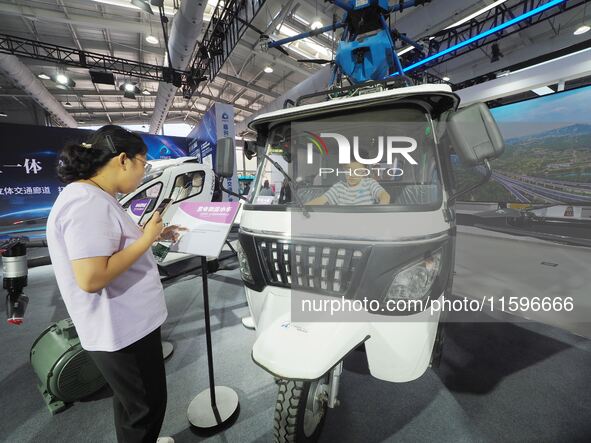 A child experiences a ''hydrogen electric logistics car'' at the 16th International Transportation Technology and Equipment Exhibition in Be...