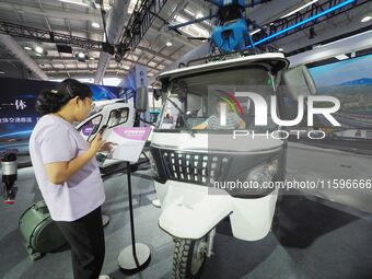 A child experiences a ''hydrogen electric logistics car'' at the 16th International Transportation Technology and Equipment Exhibition in Be...