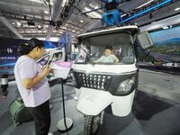 A child experiences a ''hydrogen electric logistics car'' at the 16th International Transportation Technology and Equipment Exhibition in Be...