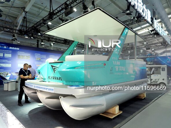 Visitors view a ''hydrogen yacht'' at the 16th International Transportation Technology and Equipment Exhibition in Beijing, China, on Septem...