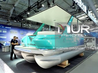 Visitors view a ''hydrogen yacht'' at the 16th International Transportation Technology and Equipment Exhibition in Beijing, China, on Septem...