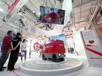 Visitors visit the ''sixth generation intelligent delivery vehicle'' at the booth of JD.com Logistics at the 16th International Transportati...