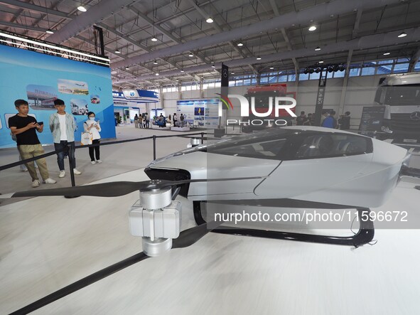 Visitors visit the ''Xiaopeng Pure Electric Flying Car'' at the 16th International Transportation Technology and Equipment Exhibition in Bei...